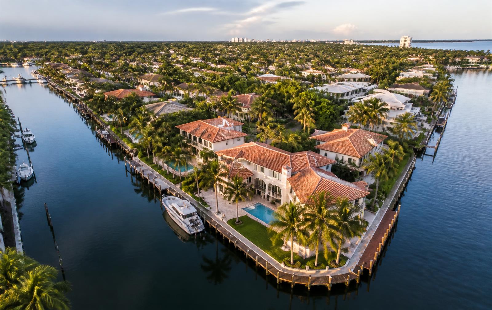 Aerial view of an upscale South Florida waterfront neighborhood with tile roofs
